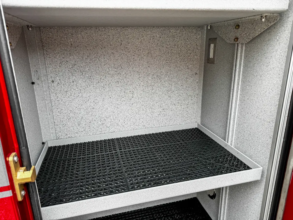 Compartment interior close-up showing lower bay and side-wall track.